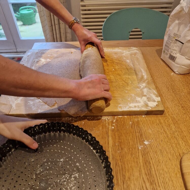 Picking up pastry dough on rolling pin
