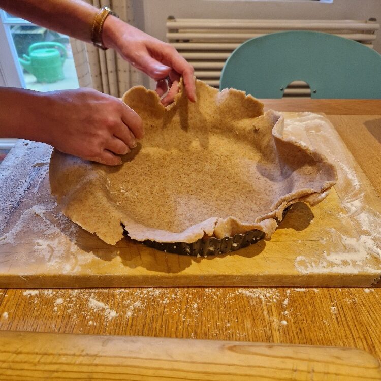 Fitting pastry dough to tin