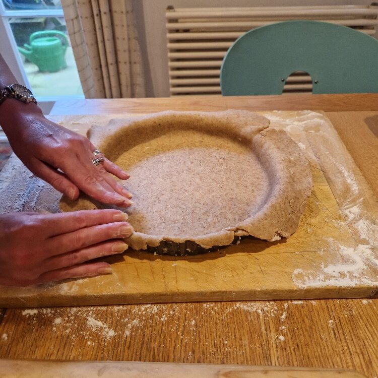 Fitting pastry dough to tin