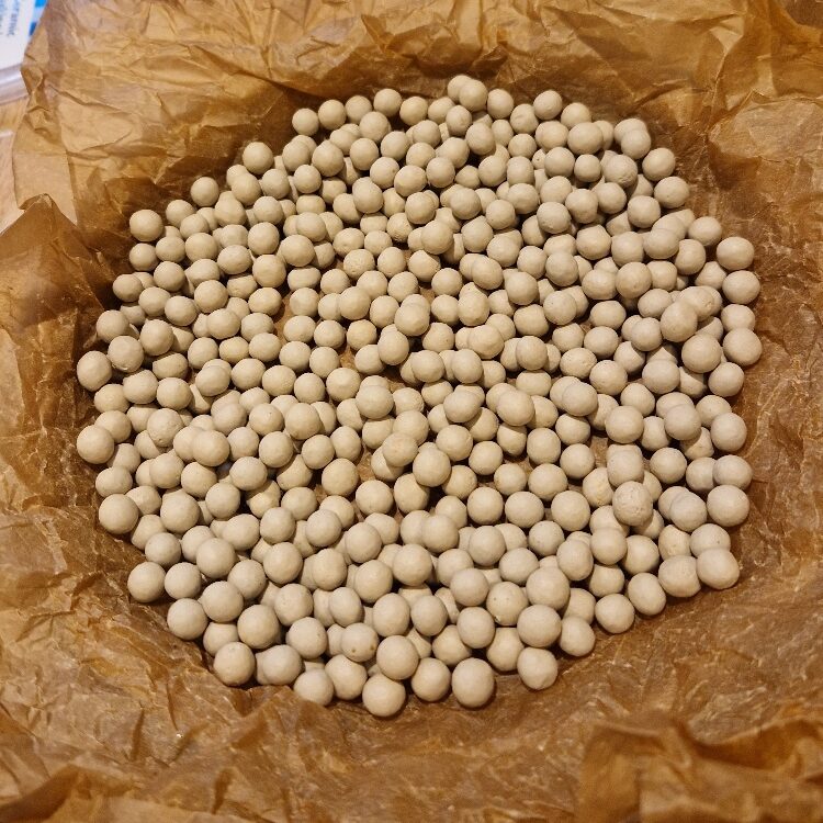 Adding baking beans to the lined tin
