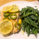 baked fish with a big pile of beans