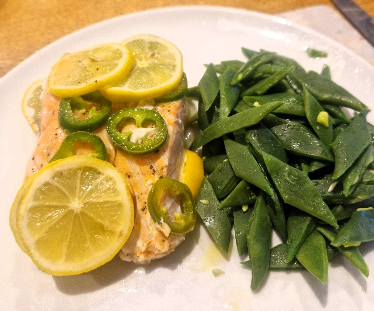 baked fish with a big pile of beans